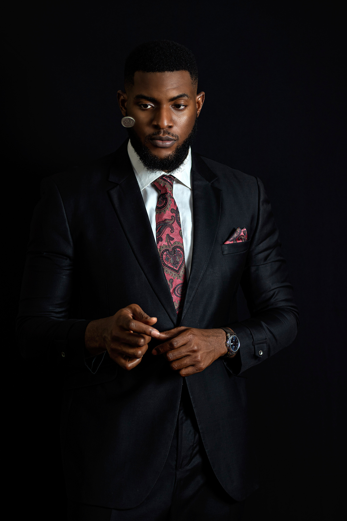 Man in Black Suit Flipping a Coin